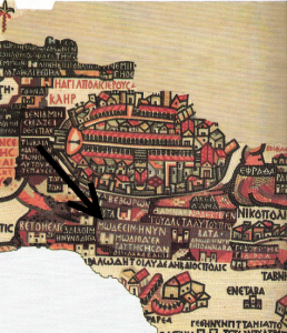 Portion of the Madaba Map. Below the walled city of Jerusalem, the arrow I’ve inserted points to the Greek words: MOΔΕΕΙΜ · Η ΝΥΝ ΜWΔΙΘΑ ˙ ΕΚ ΤΑΥΤΗC HCAN OI MAKKABAAIOI (“Modi’in, which is today Moditha; home of the Maccabees”). 
